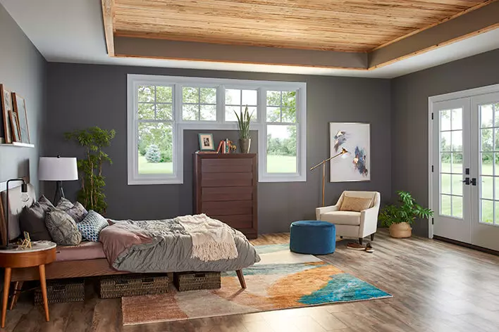 Well-lit bedroom with sun coming in through the windows