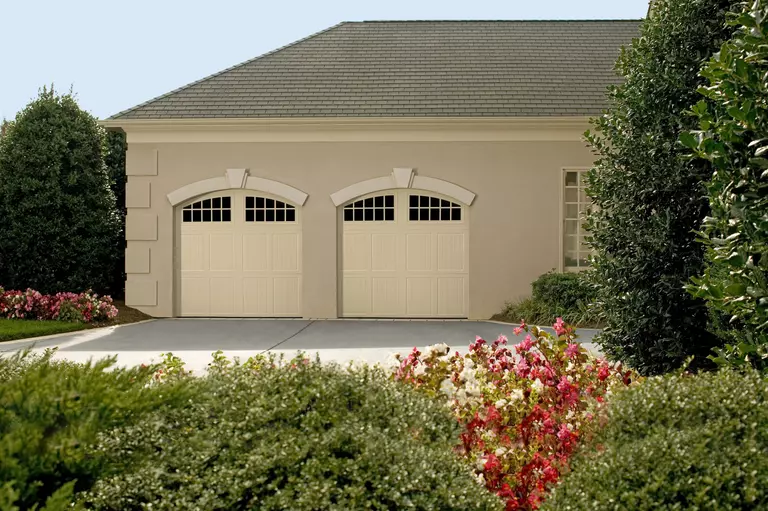 Exterior of a home with beige garage doors.