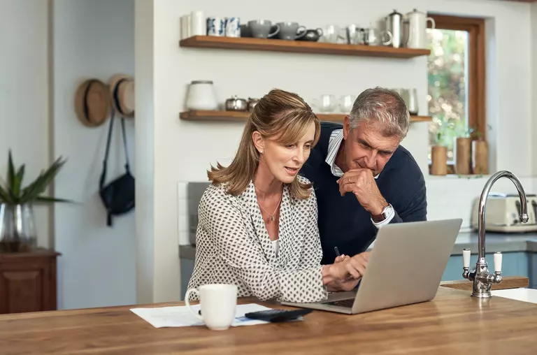 A senior couple reviewing finances in their home while planning for a home remodel.