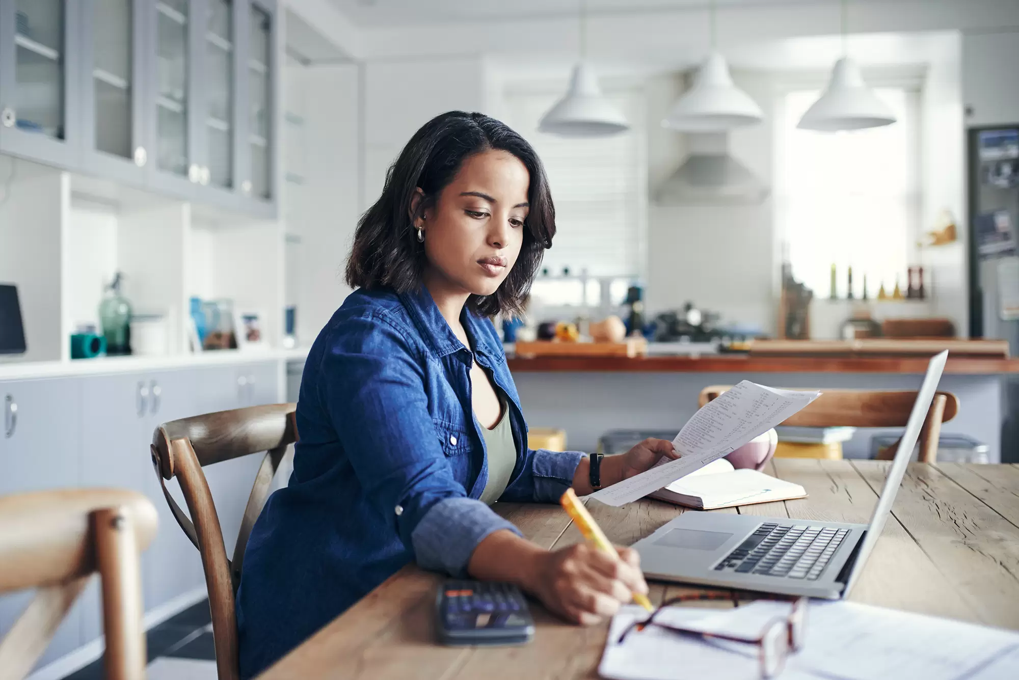 Woman going over paperwork and financial information.