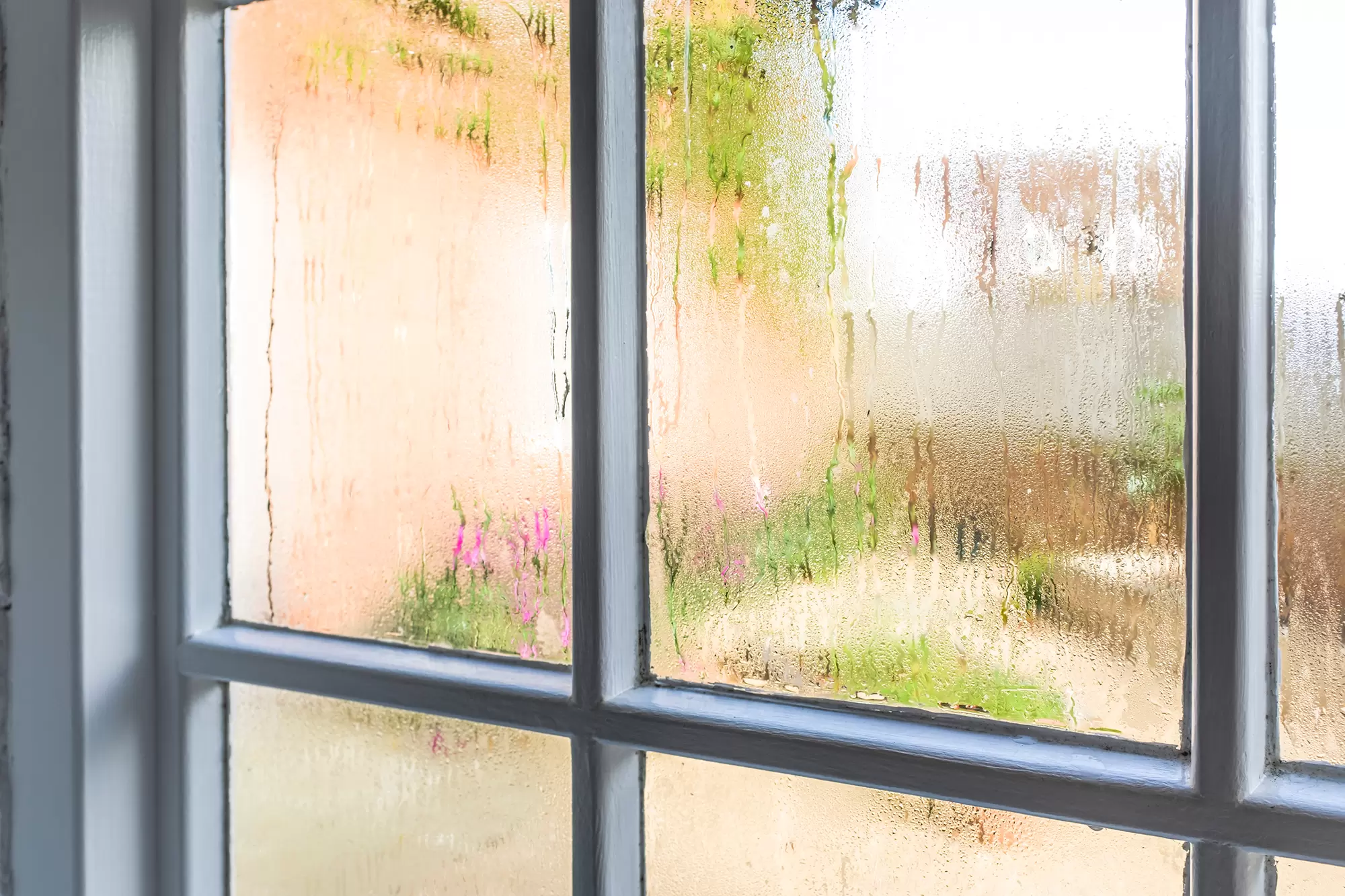 Window with condensation and streaks from moisture.