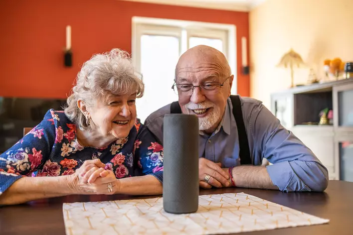 An older couple learning how to use new smart devices in their age-in-place home.