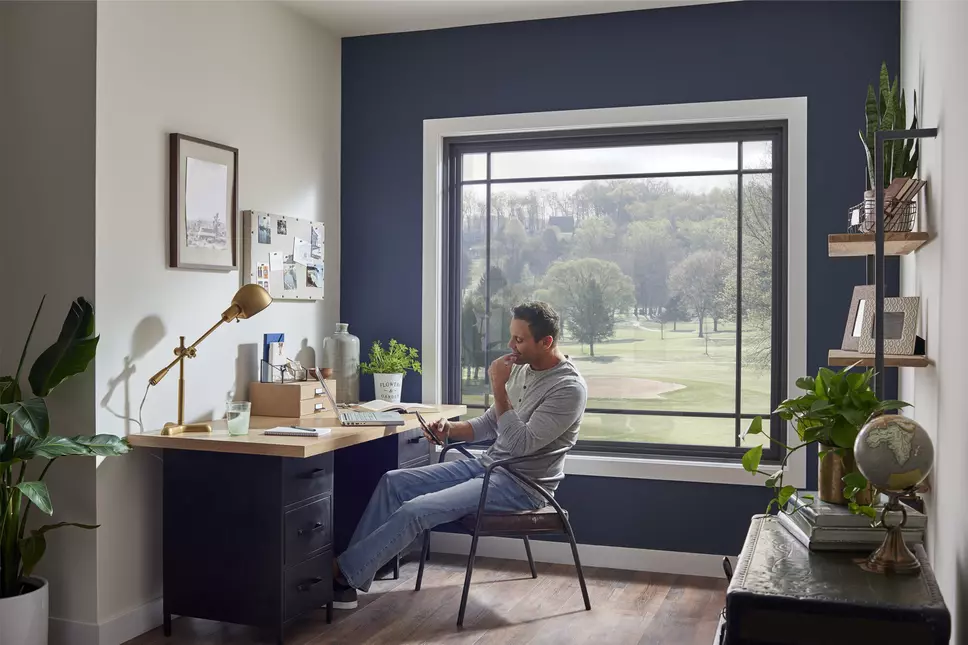 Image of man sitting at a desk in his home office