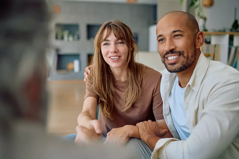 Man and woman meeting with salesperson.