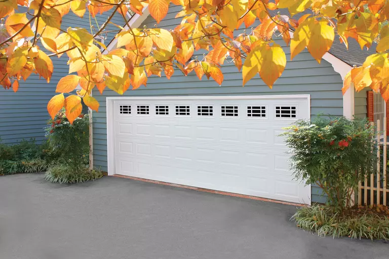 Home with a white raised-panel garage door.