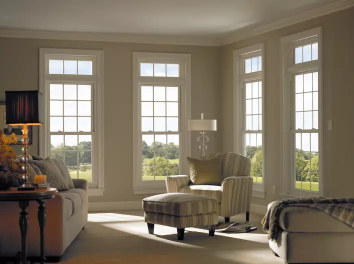 A sunny living room with four Low-E windows in the background. Sunlight filters into the room from a low angle.
