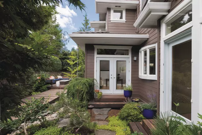 Traditional home with a smooth steel door, with a Full Lite door style and Enclosed Blinds glass, prefinished in Oxford White – 160, with hardware in Satin Nickel.