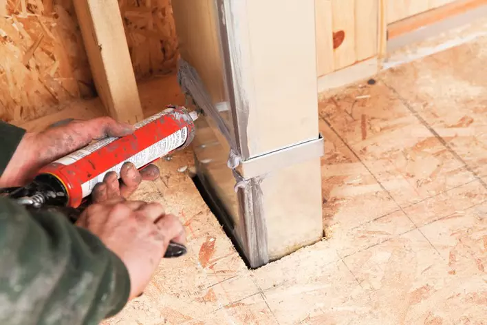 A person tuning up the ventilation system of a home to increase energy-efficiency throughout the house.
