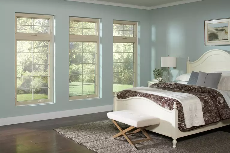 A bedroom with three similar windows using casement and awning configurations.