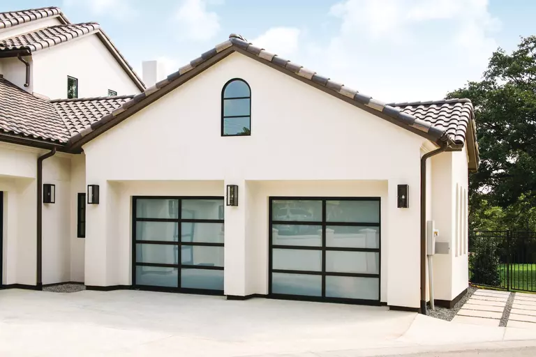 Home with a stucco exterior and two Wayne Dalton garage doors.