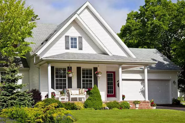 Frontal view of a white farmhouse-style home