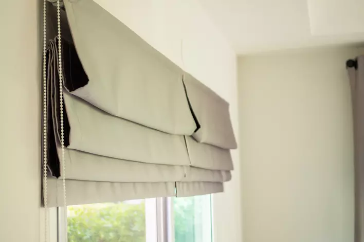 Roman shades over patio doors as window treatments
