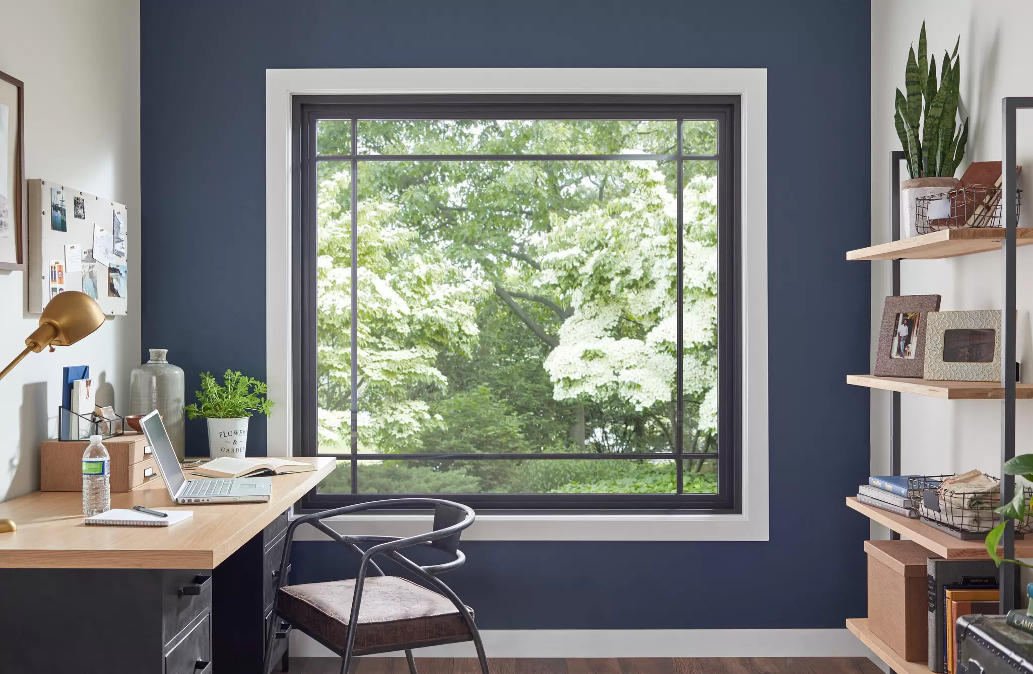 Home office with a black picture window.