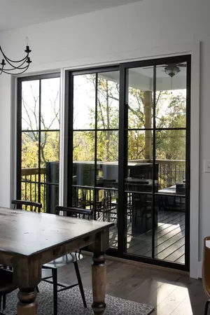A kitchen with a black sliding patio door connecting to a covered porch.