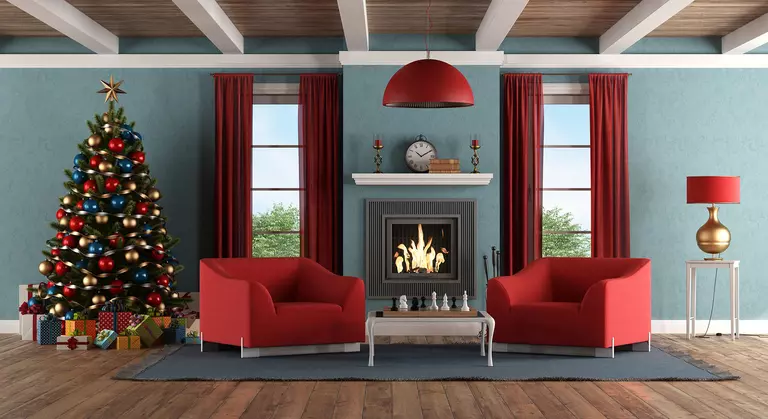A pair of living room windows with red curtains for the holidays.