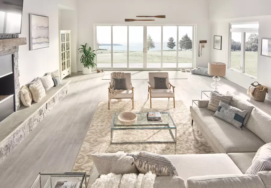 A living room with large windows and a waterfront view